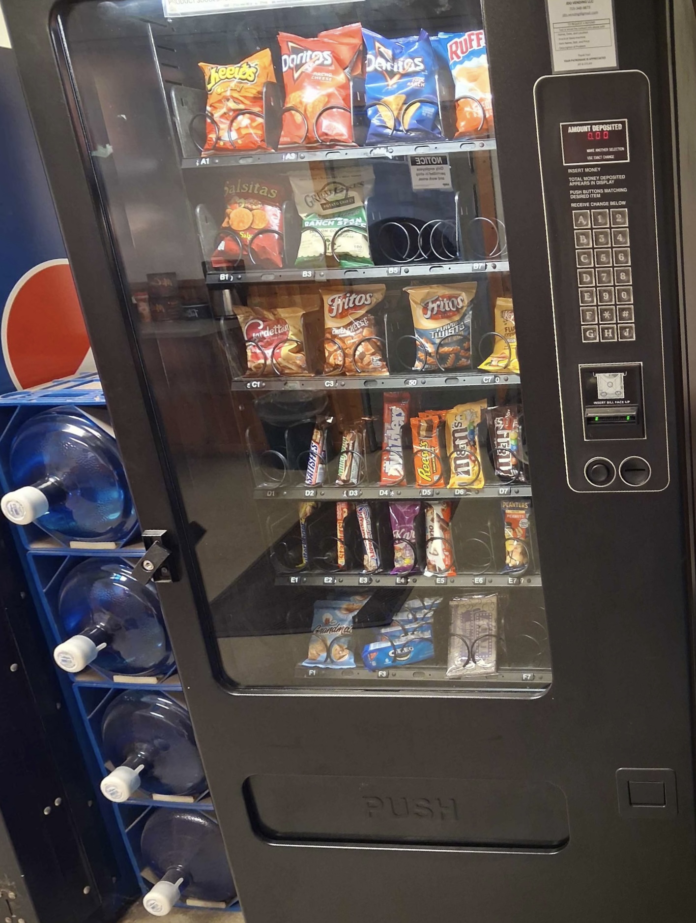 JDO Vending snack machine next to water jug storage
